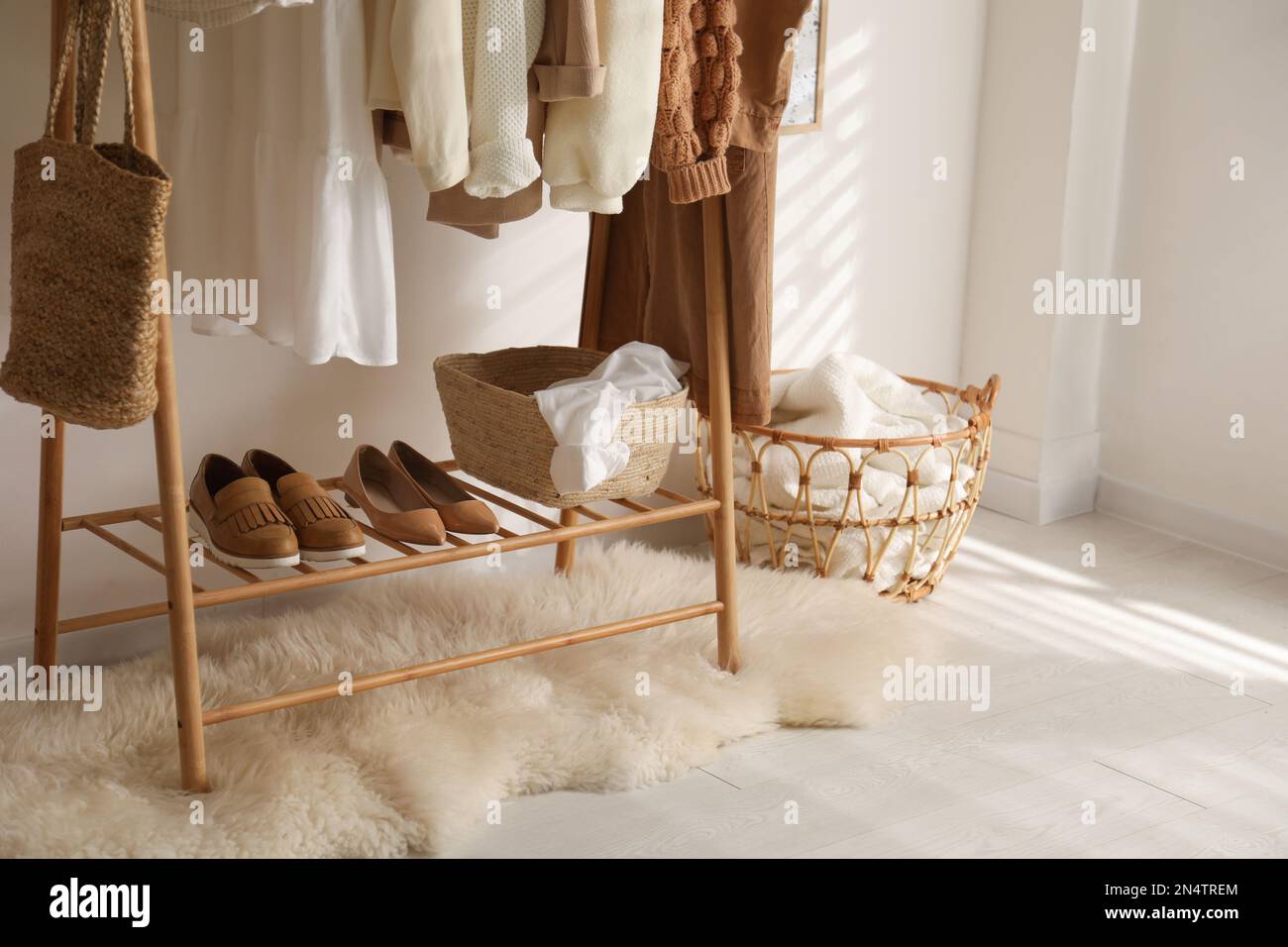 https://c8.alamy.com/comp/2N4TREM/rack-with-stylish-shoes-and-womens-clothes-in-dressing-room-modern-interior-design-2N4TREM.jpg