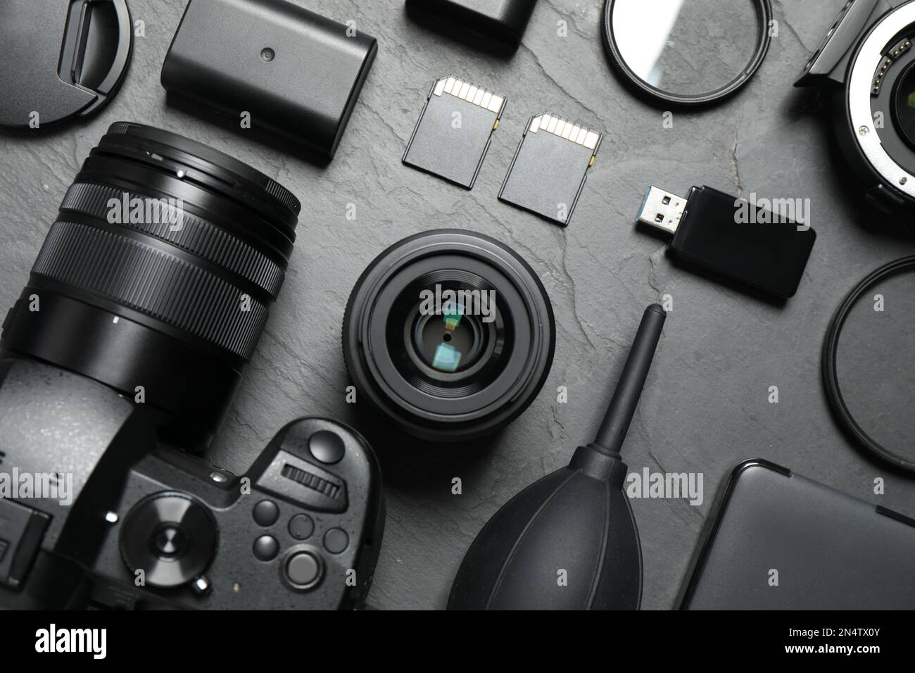 Flat lay composition with camera and video production equipment on grey ...