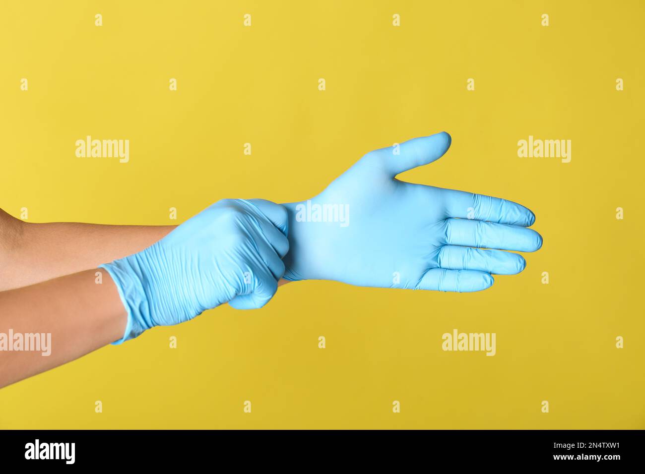 Putting on latex gloves yellow hi-res stock photography and images - Alamy