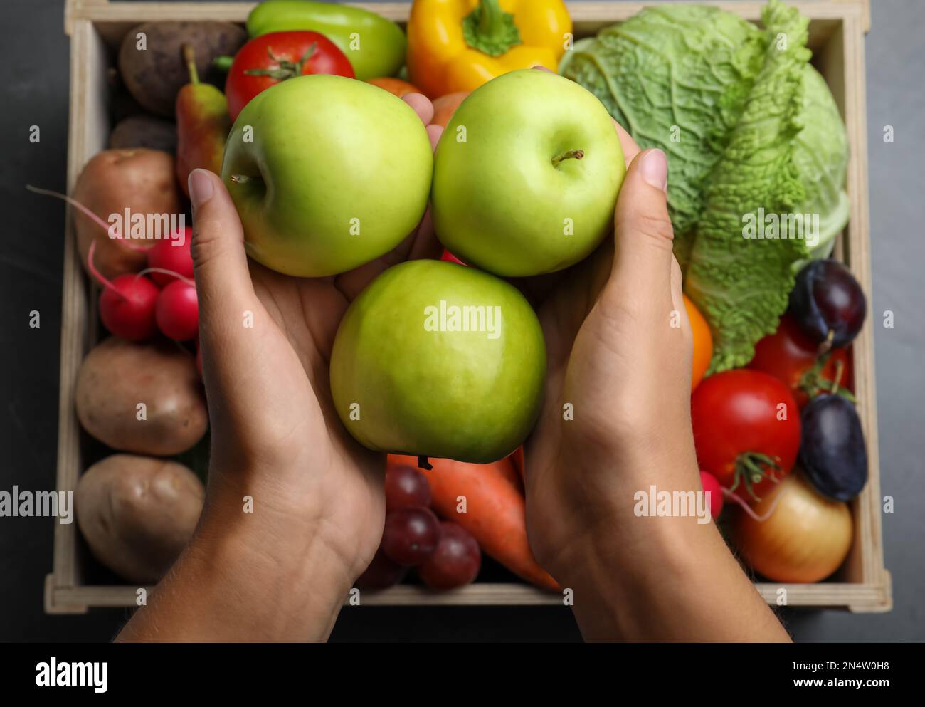 Farmer with wooden crate full of different vegetables and fruits at ...