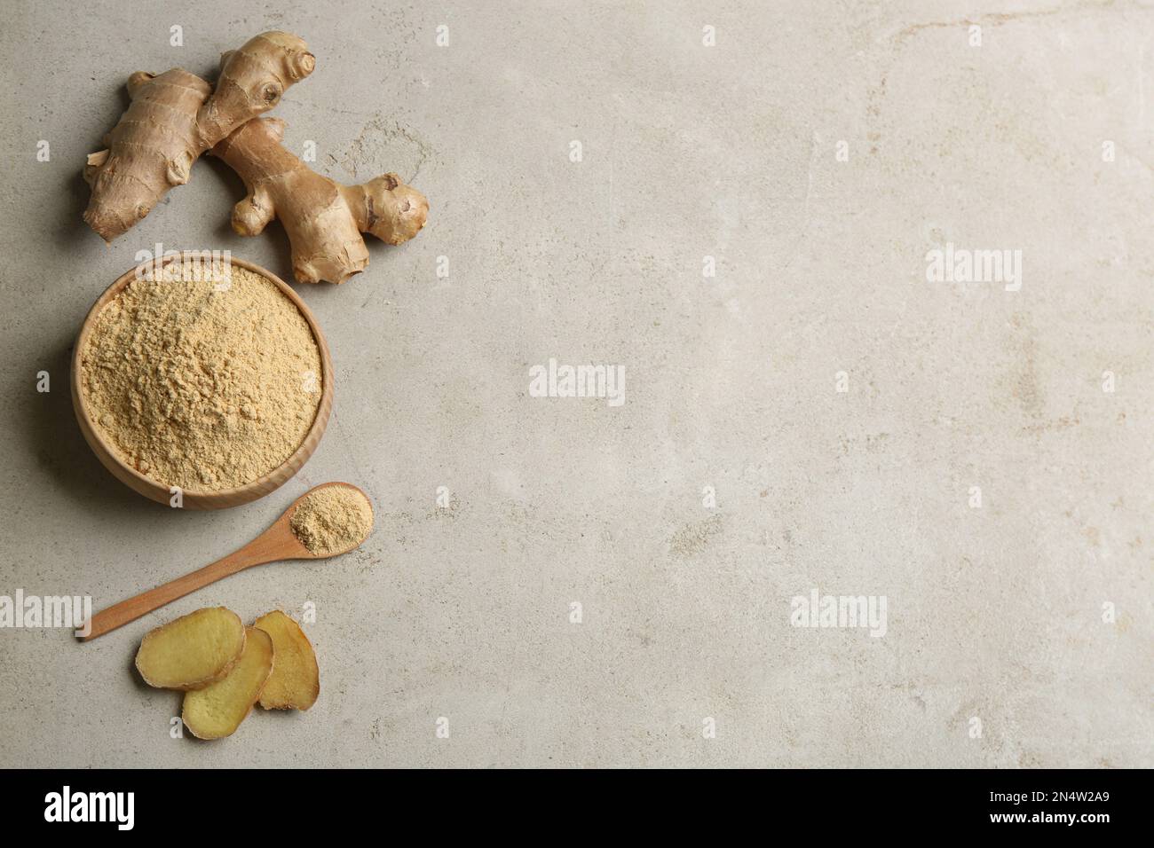 Flat lay composition with fresh and dry ginger on light grey table ...