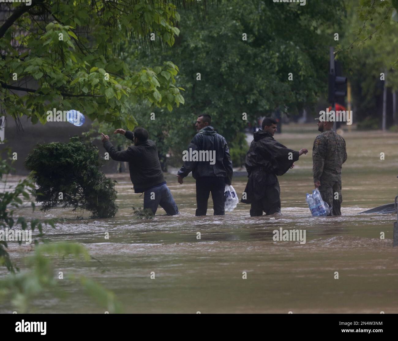 Bosnian volunteers distribute food supplies to people stranded due to ...