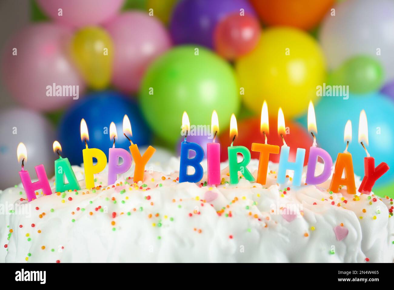 Birthday cake with burning candles on blurred background, closeup Stock ...
