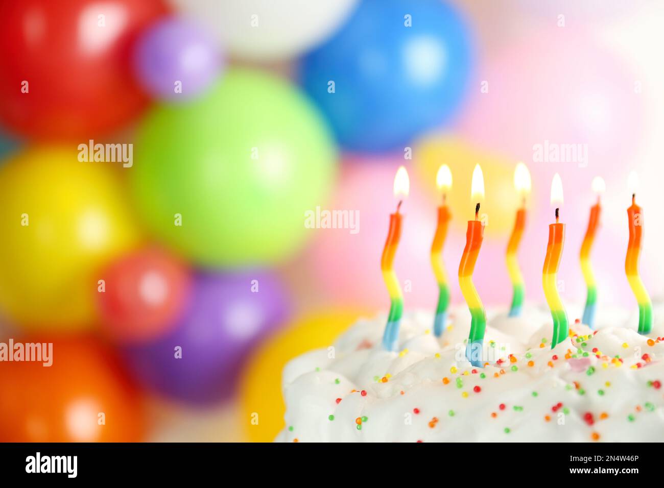 Birthday cake with burning candles on blurred background, closeup ...
