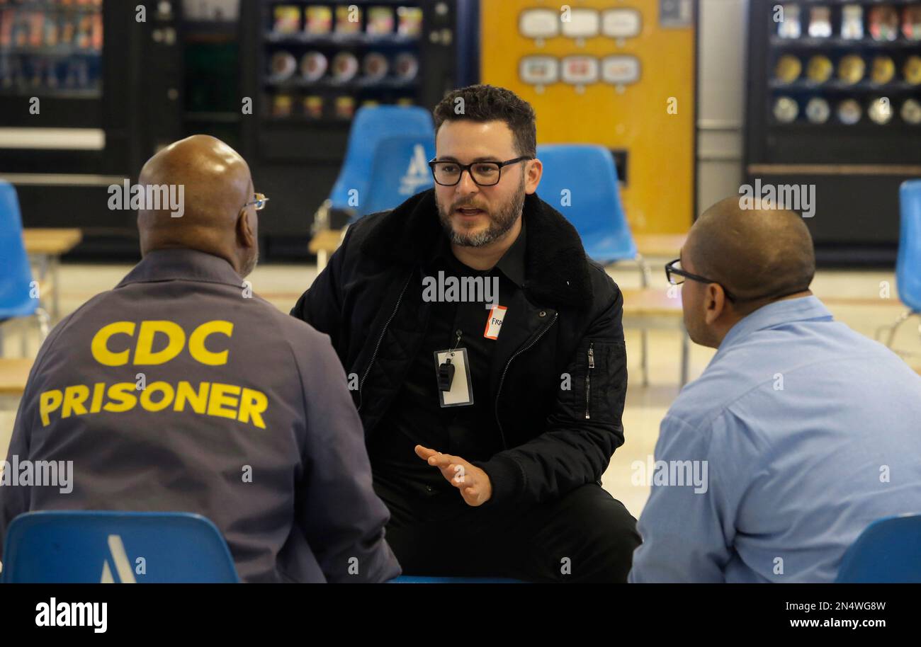 Volunteer mentor Francisco Fuentes meets with students Lee Swafford, (left)  and Edgar Muniz (right) as Defy Ventures holds a business pitch competition  for prisoners enrolled in the entrepreneurs in training program, at