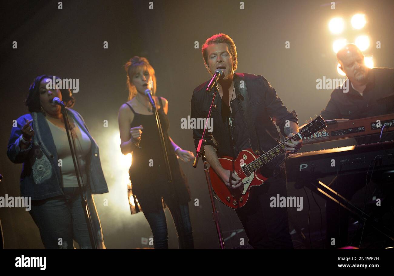 Joe Don Rooney, second from right, of Rascal Flatts performs at the iHeart Radio  Country Live Series on Monday, May 12, 2014 in Burbank, Calif. (Photo by  Chris Pizzello/Invision/AP Stock Photo -