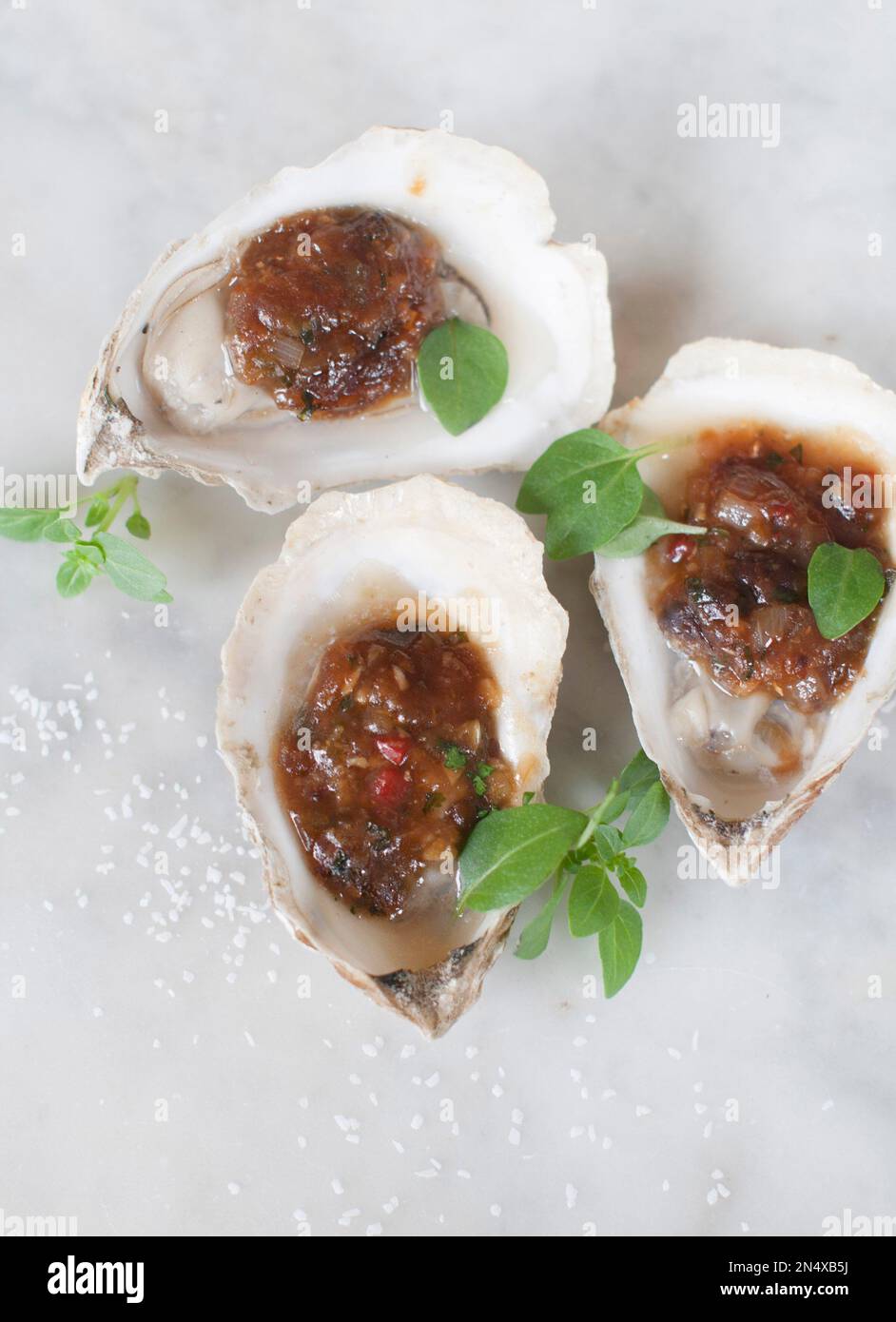 This Apr. 7, 2014 photo shows grilled oysters with fermented black