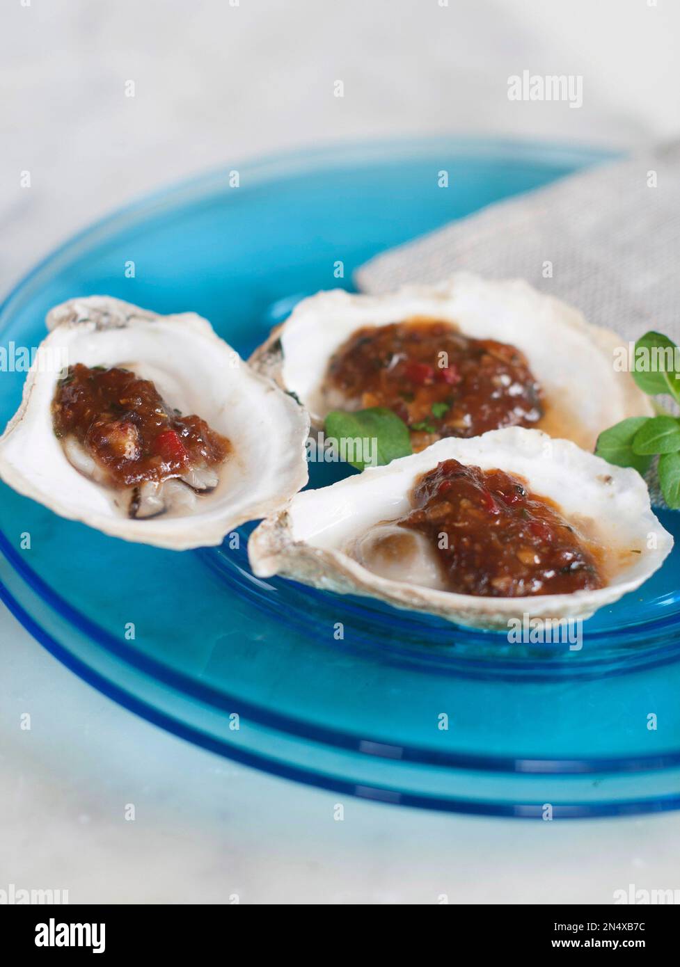 This Apr. 7, 2014 photo shows grilled oysters with fermented black