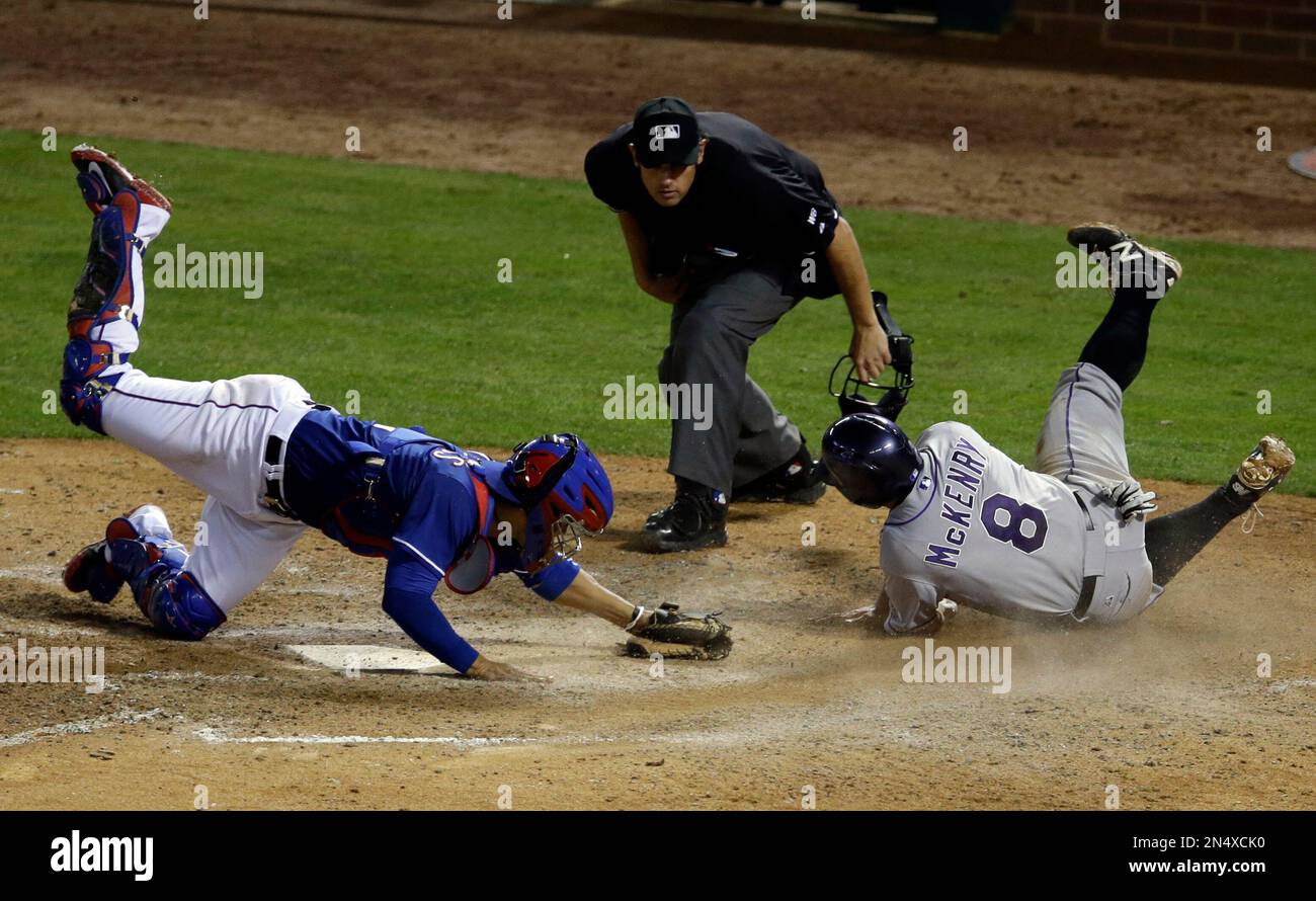 Home plate umpire Mark Ripperger watches a close play at the plate ...
