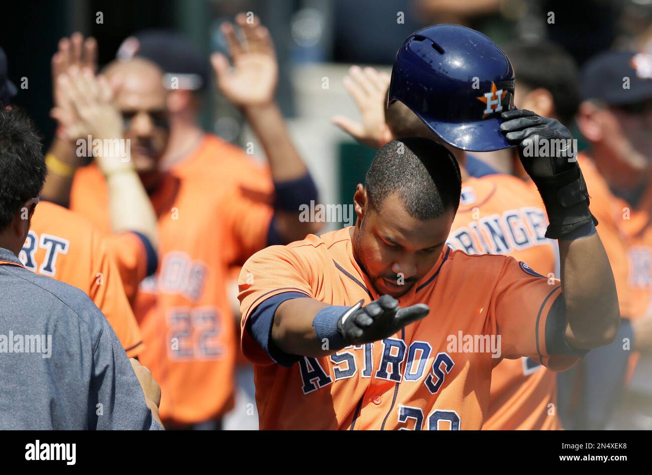 Houston Astros' L.J. Hoes takes his helmet off after arriving in
