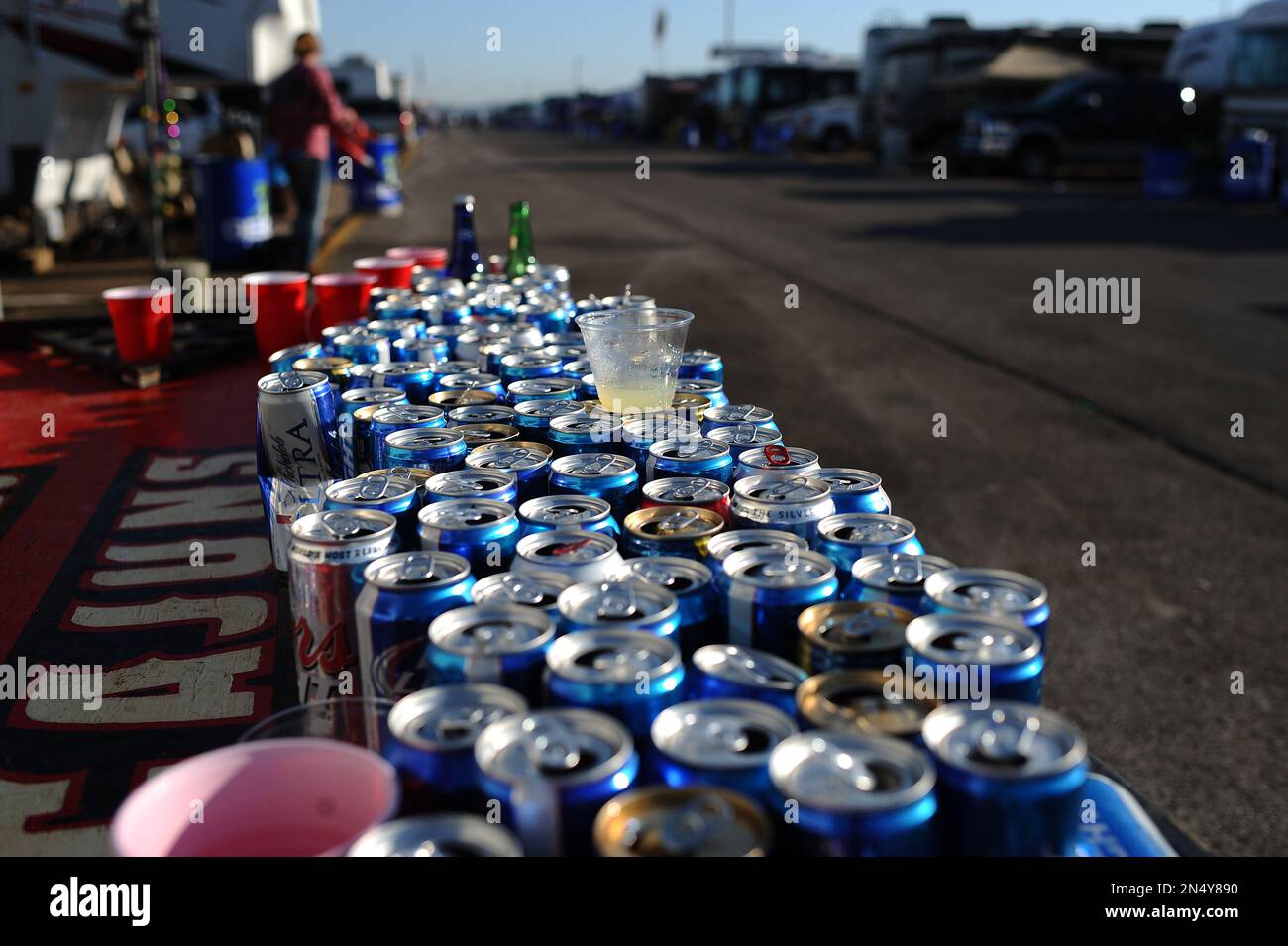 Empty beer cans sit on a table in the infield before the NASCAR Aaron's