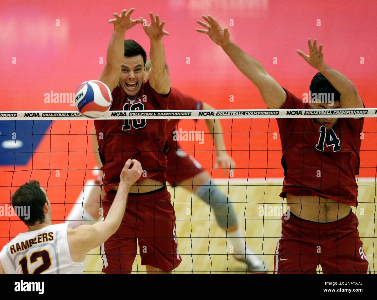 Stanford's Brian Cook (10) and Spencer Haly (14), right, block the ball