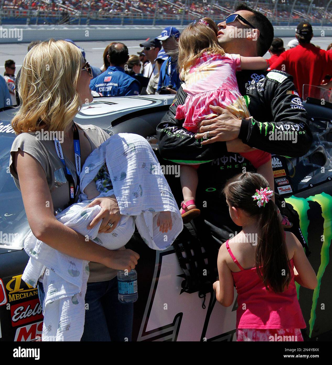 Driver Sam Hornish Jr., holds his daughter with his family about before
