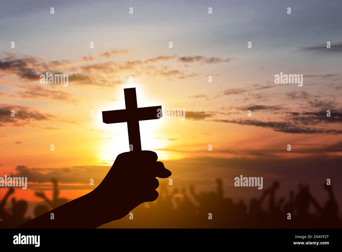 Human hand holding Christian cross with sunset sky background Stock ...