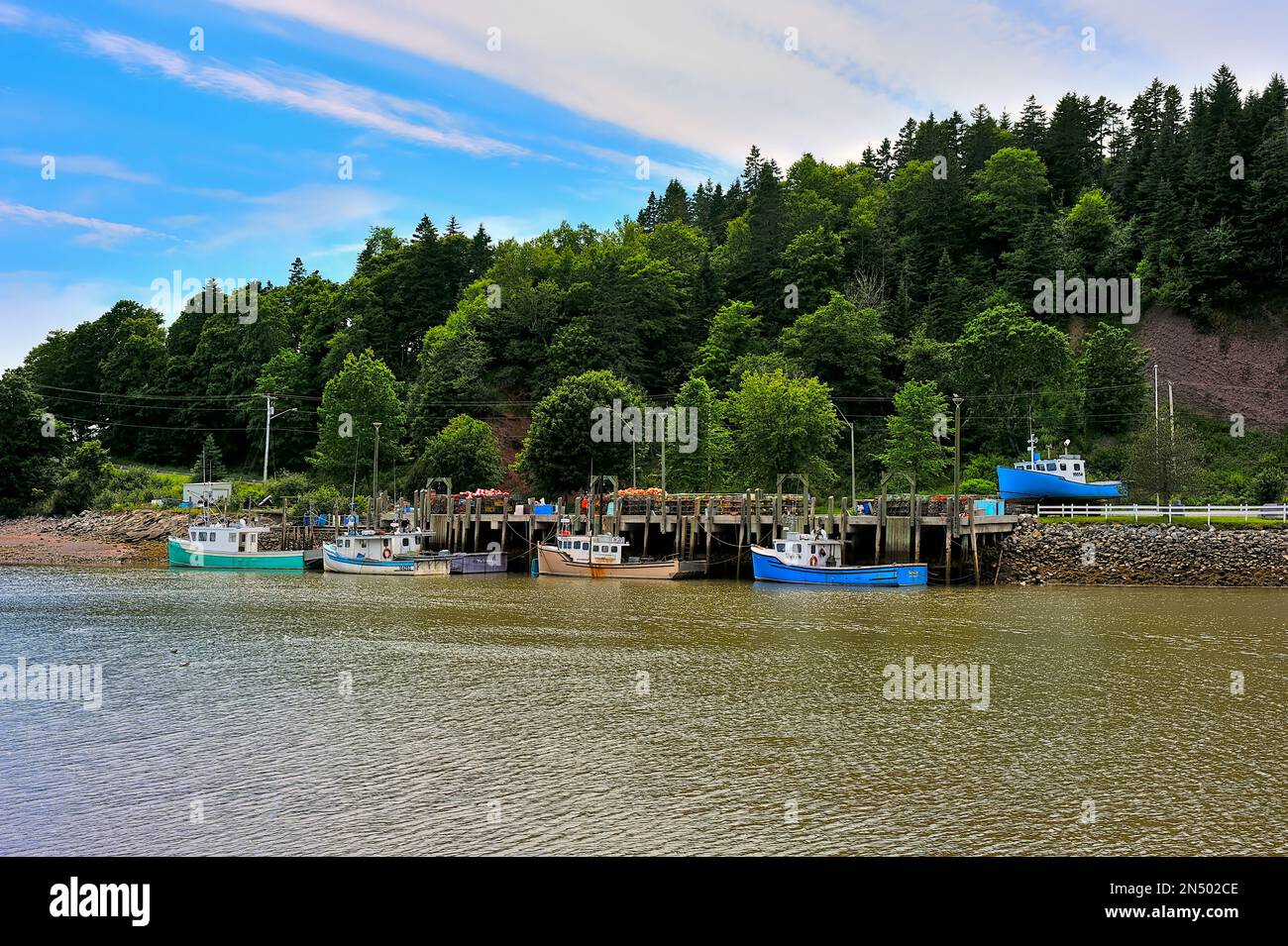 East coast fishing boats moored to the wharf in Saint Martins New Brunswick, Canada Stock Photo
