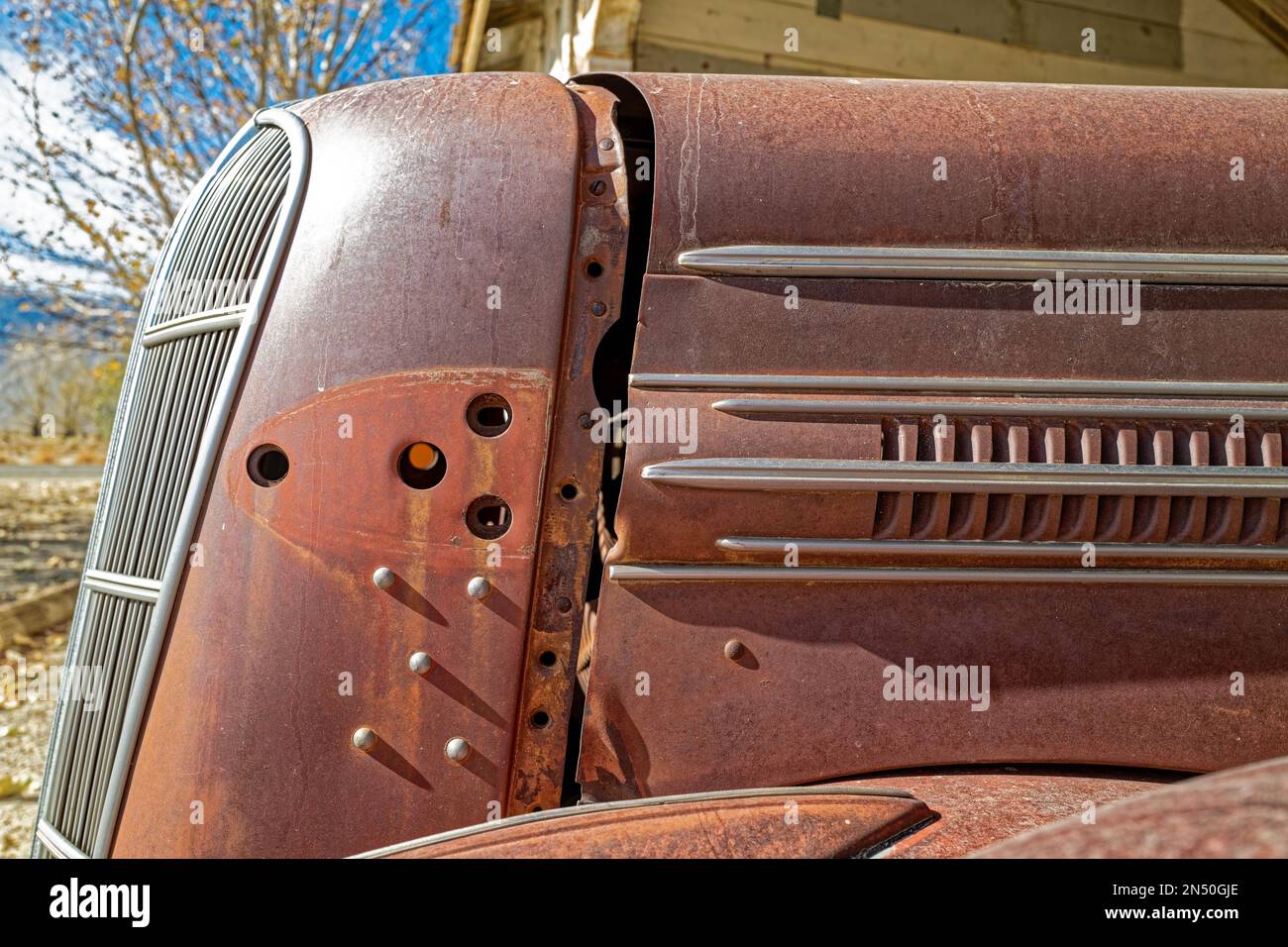 Hood vents on the side of a rusty antique car resting in the desert, Nevada, USA Stock Photo