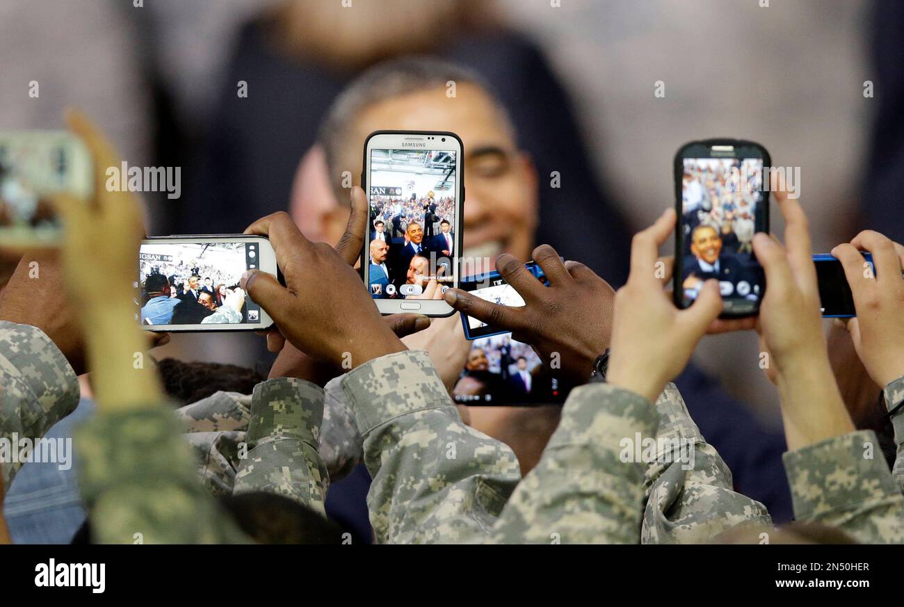 U.S. military soldiers using their smartphones take pictures of U.S. President Barack Obama