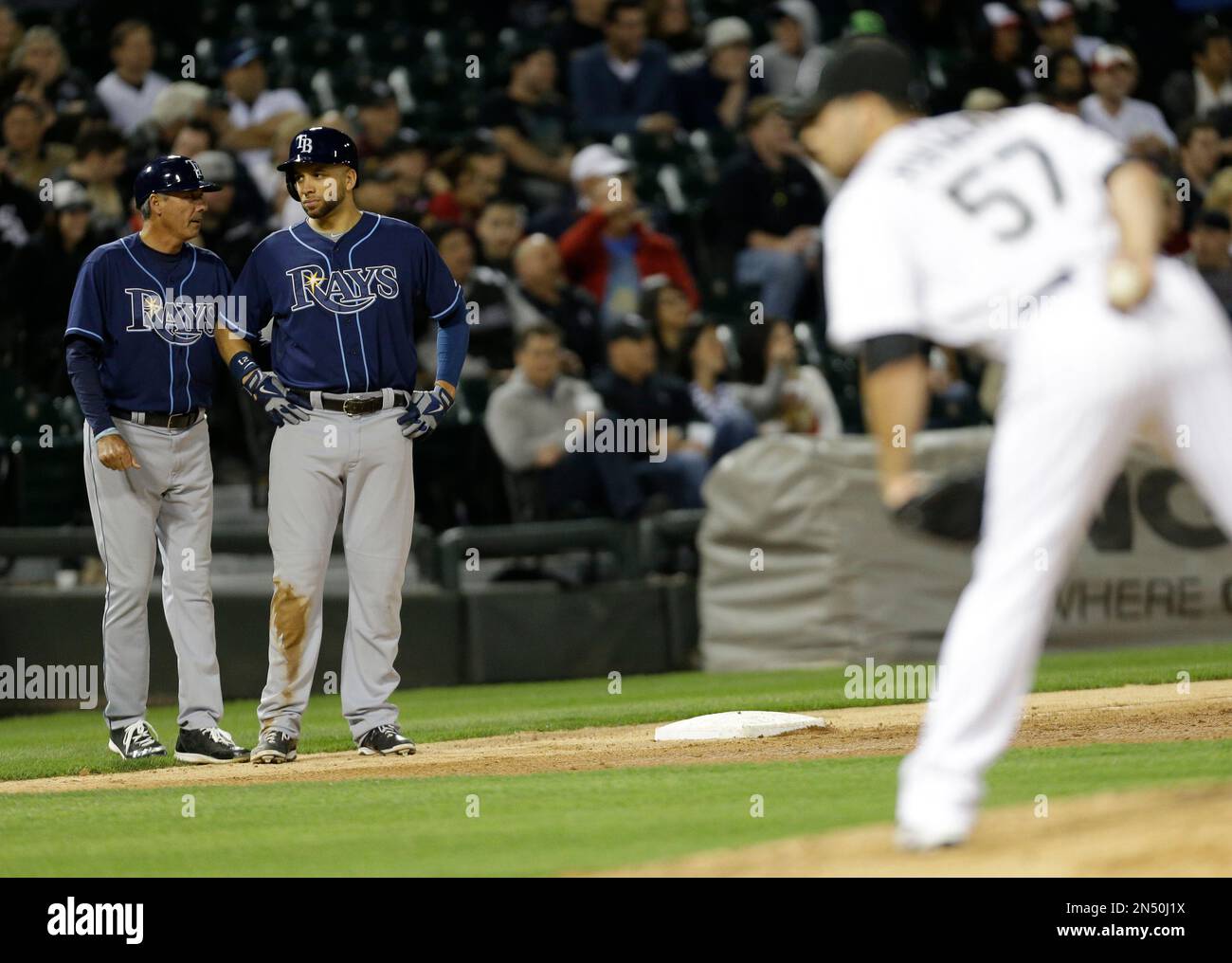 Tampa Bay Rays third base coach Tom Foley, left, talks to James Loney