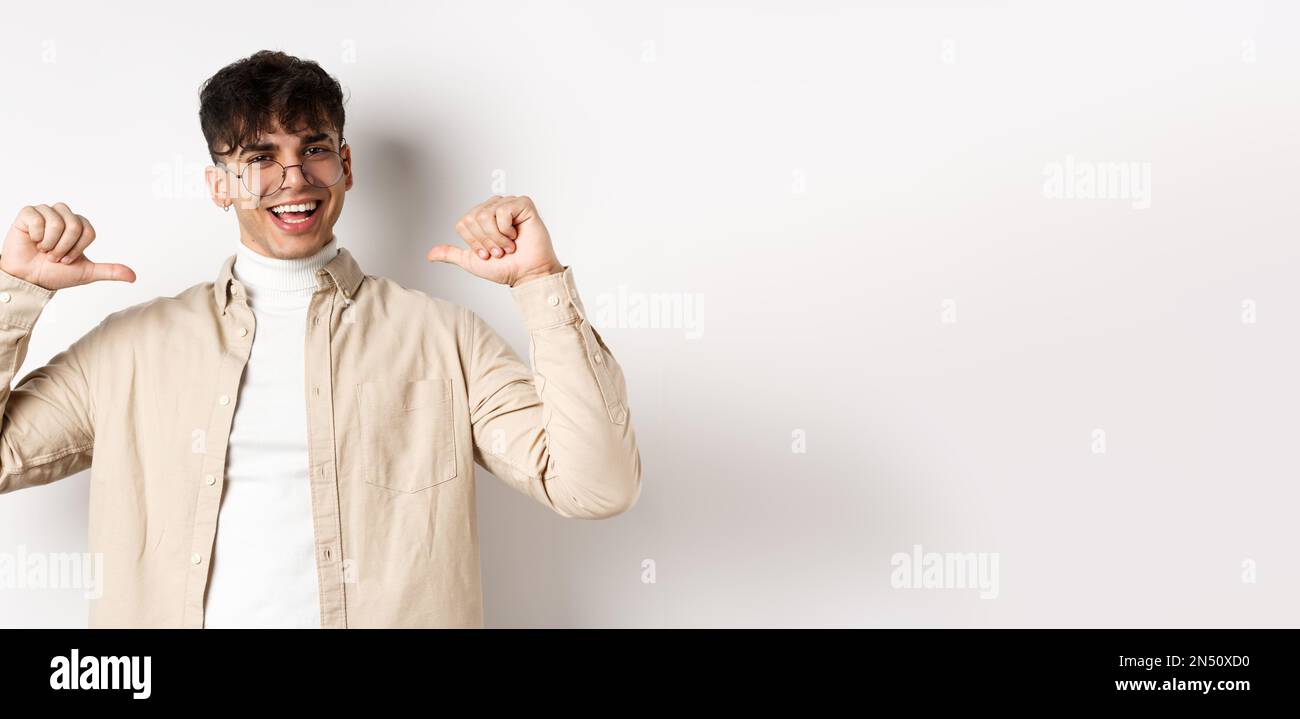 Image of motivated smiling handsome man pointing at himself, self