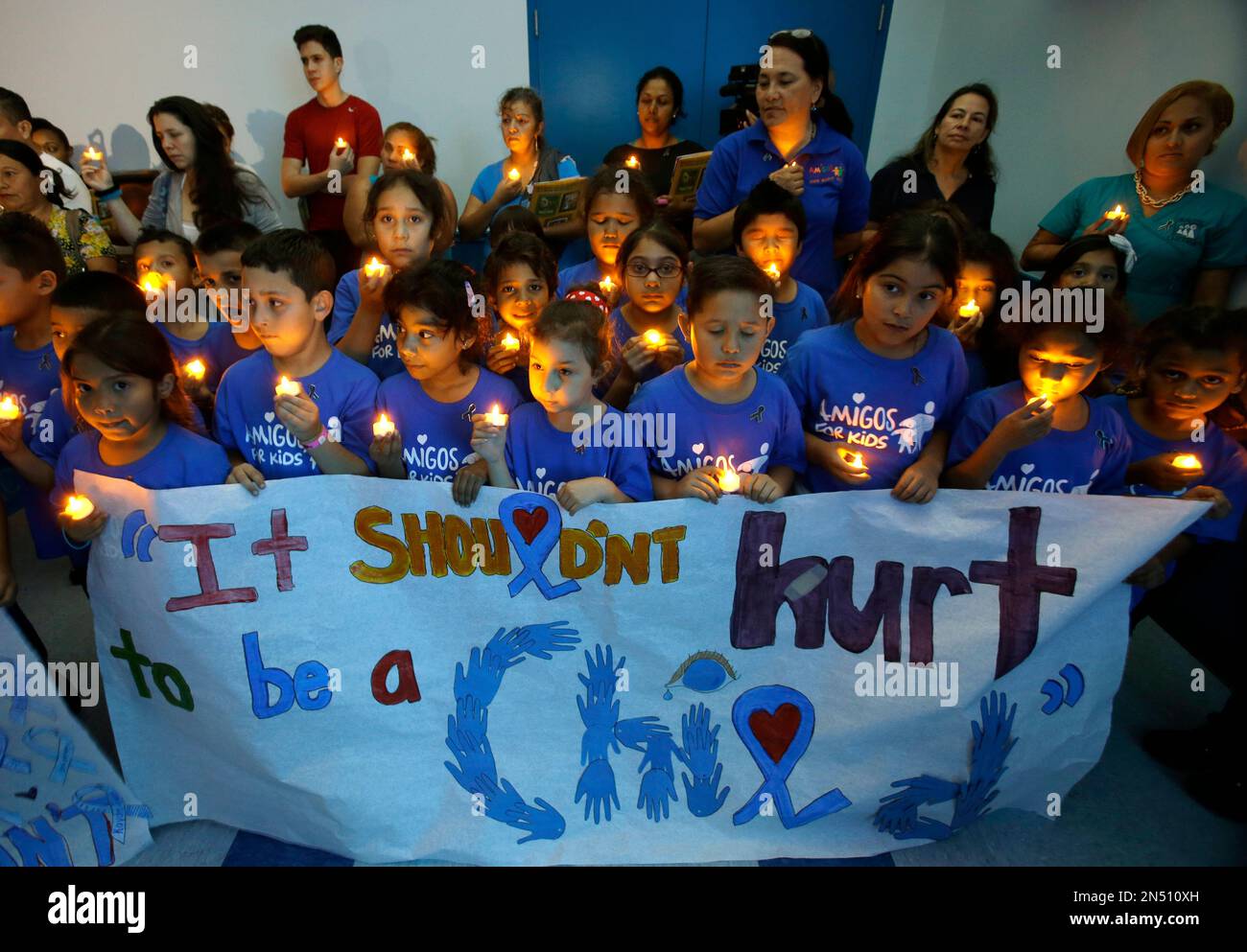 Children from an after school program participate in a candlelight ...
