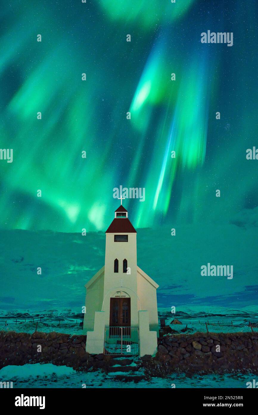 A northern lights aurora borealis over church in Iceland Stock Photo