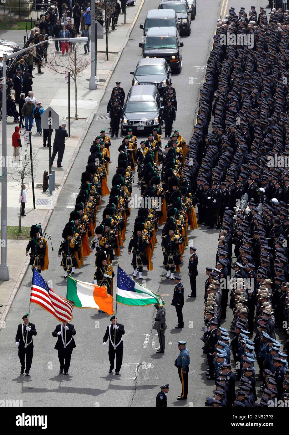 The funeral procession for officer dennis guerra moves slowly past