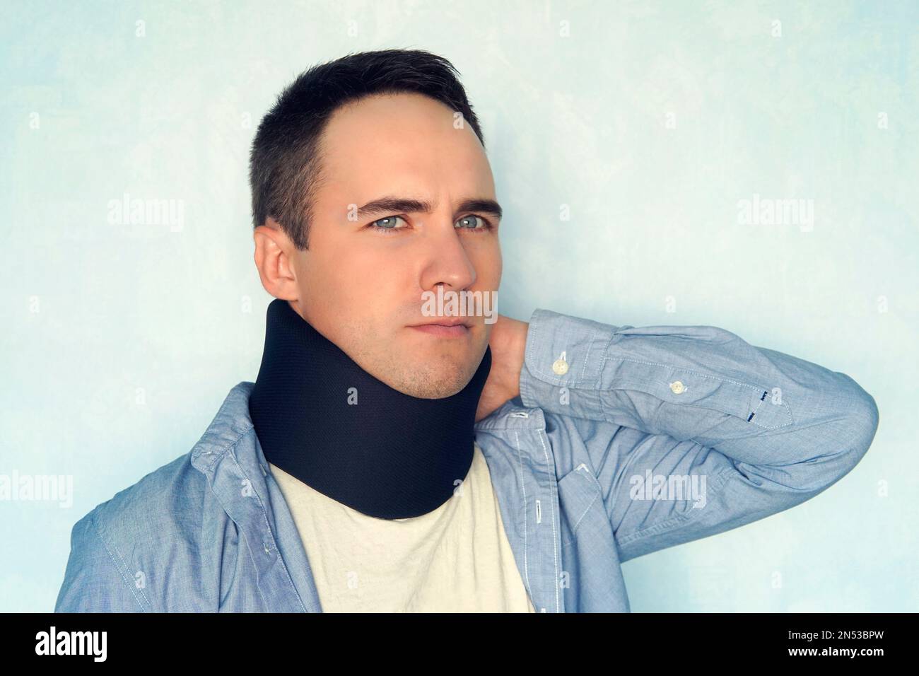 A guy with a bad neck in a black neck collar to stabilize the cervical