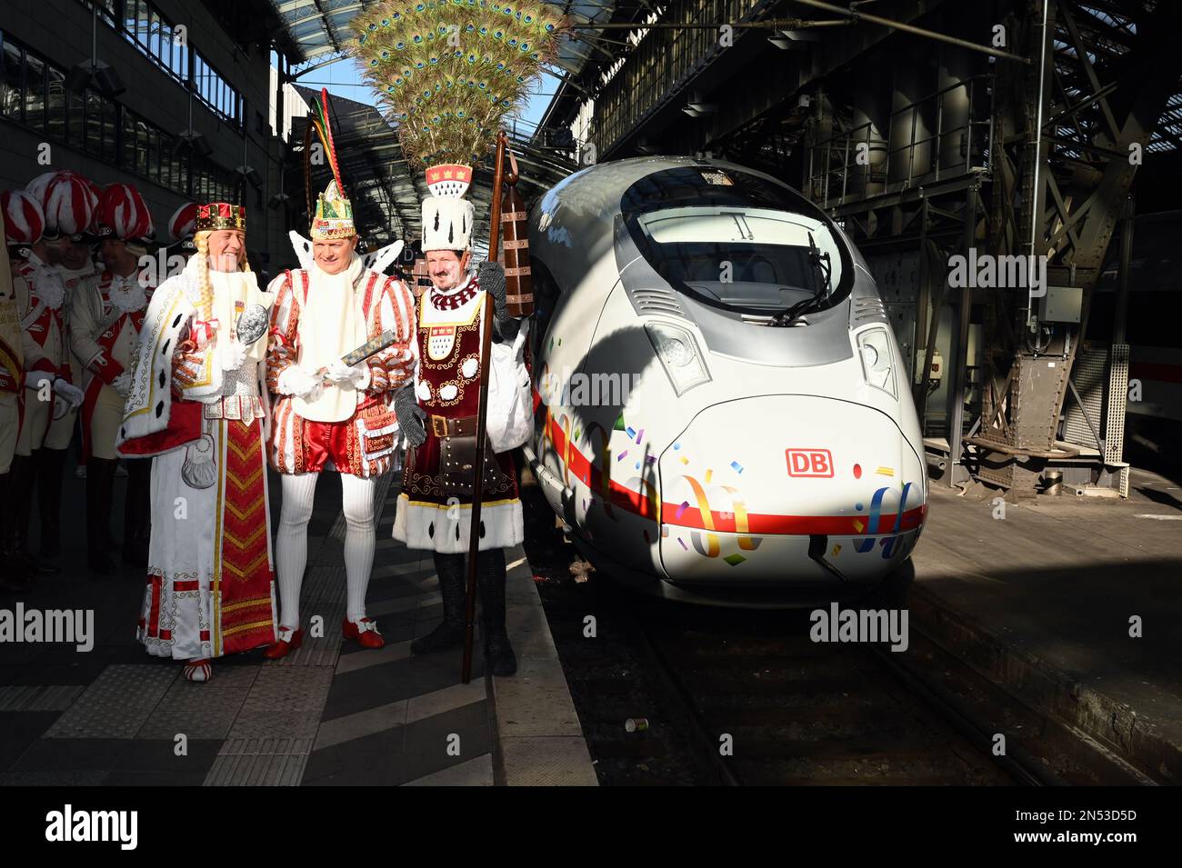 Cologne, Germany. 08th Feb, 2023. The Cologne carnival triumvirate Maiden Agrippina (Andre Fahnenbruck), Prince Boris I (Boris Müller) and Peasant Marco (Marco Schneefeld, l-r, stand on the platform in front of ICE at the christening of the first ICE 3 Neo on the name 'Rhineland' in time for 200 years of Cologne Carnival Credit: Horst Galuschka/dpa/Alamy Live News Stock Photo