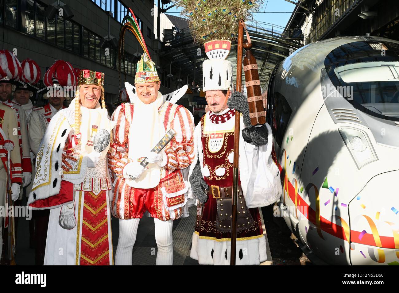 Cologne, Germany. 08th Feb, 2023. The Cologne carnival triumvirate Maiden Agrippina (Andre Fahnenbruck), Prince Boris I (Boris Müller) and Peasant Marco (Marco Schneefeld, l-r, stand on the platform in front of ICE at the christening of the first ICE 3 Neo on the name 'Rhineland' in time for 200 years of Cologne Carnival Credit: Horst Galuschka/dpa/Alamy Live News Stock Photo