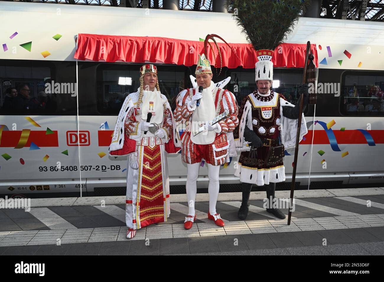 Cologne, Germany. 08th Feb, 2023. The Cologne carnival triumvirate Maiden Agrippina (Andre Fahnenbruck), Prince Boris I (Boris Müller) and Peasant Marco (Marco Schneefeld, l-r, standing on the platform at the christening of the first ICE 3 Neo with the name 'Rhineland' in time for 200 years of Cologne Carnival Credit: Horst Galuschka/dpa/Alamy Live News Stock Photo