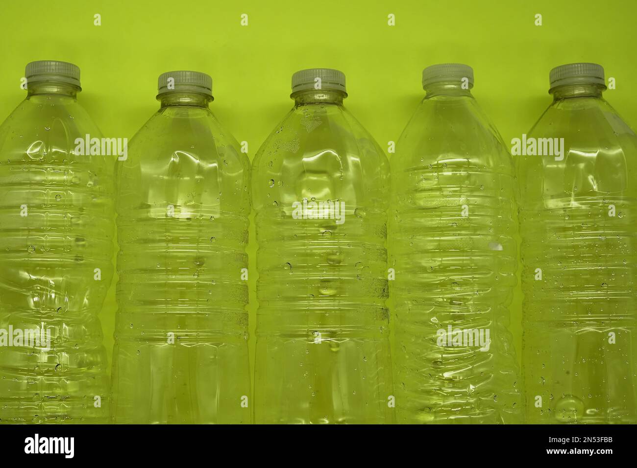Empty plastic water bottles recycle material reduce waste neon green