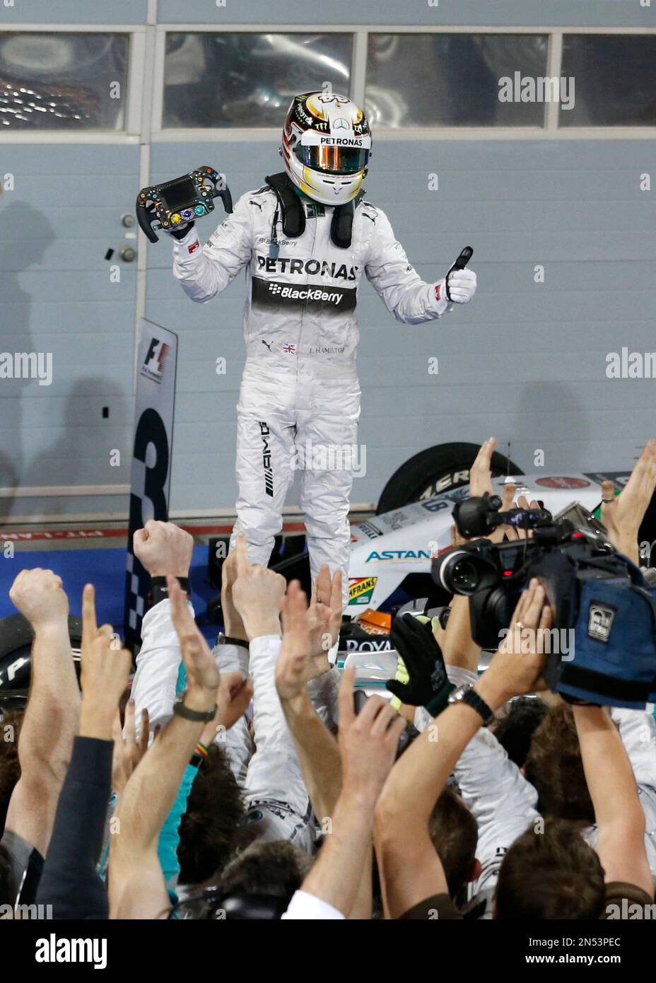 Mercedes driver Lewis Hamilton of Britain winner celebrates standing on his car after the Bahrain Formula One Grand Prix at the Formula One Bahrain International Circuit in Sakhir Bahrain Sunday April...
