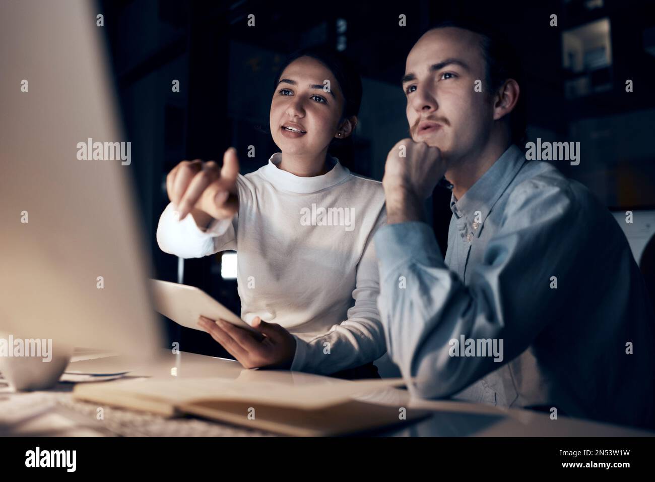Computer, teamwork and people night office for information technology, programming and software development. Programmer, coding and cybersecurity Stock Photo