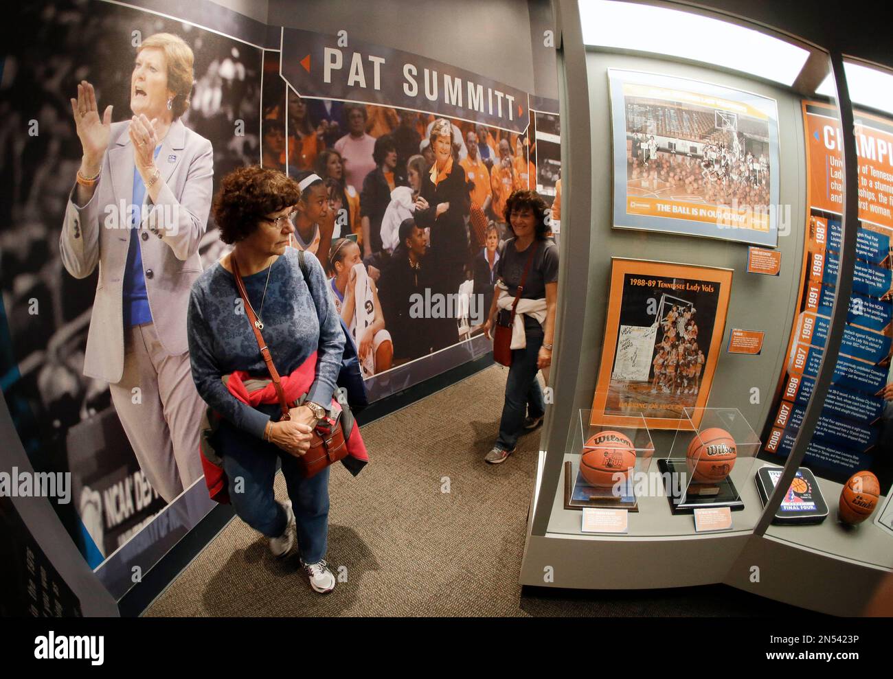 Mary Ann McElhiney, left, of East Hartford, Conn., tours the Pat Summitt  Gallery at the Tennessee Sports Hall of Fame on the opening day of the  exhibit Friday, April 4, 2014, in