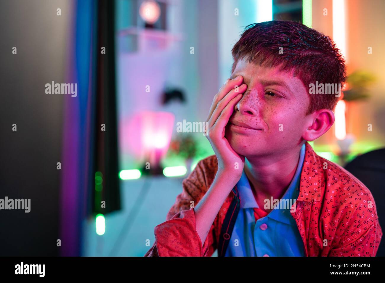 crying Teenager kid due to losing while playing online video game on computer at home - concept of cyberspace, competition and tournament Stock Photo