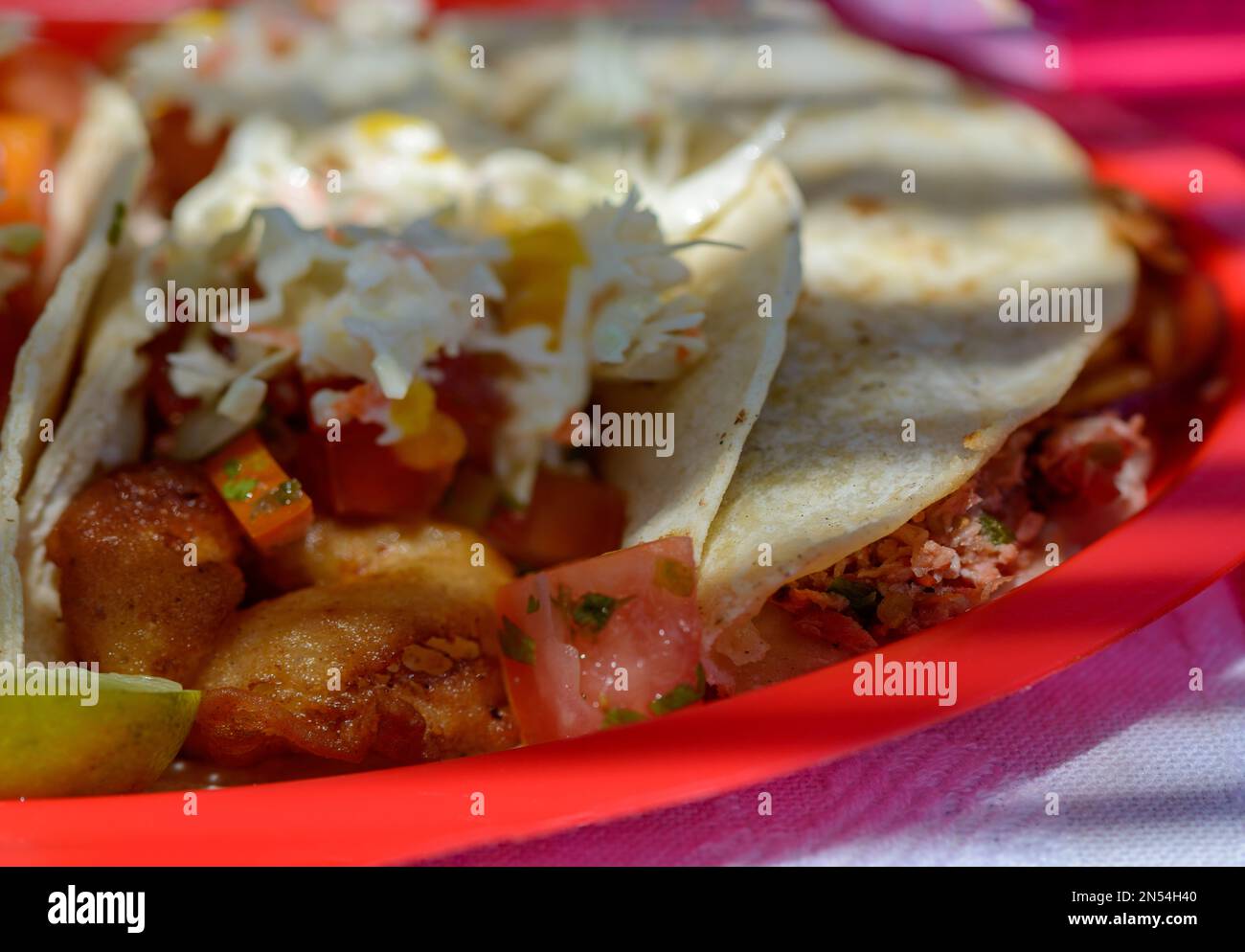 Mexican Baja fish tacos in Todos Santos with fresh sauce on colorful