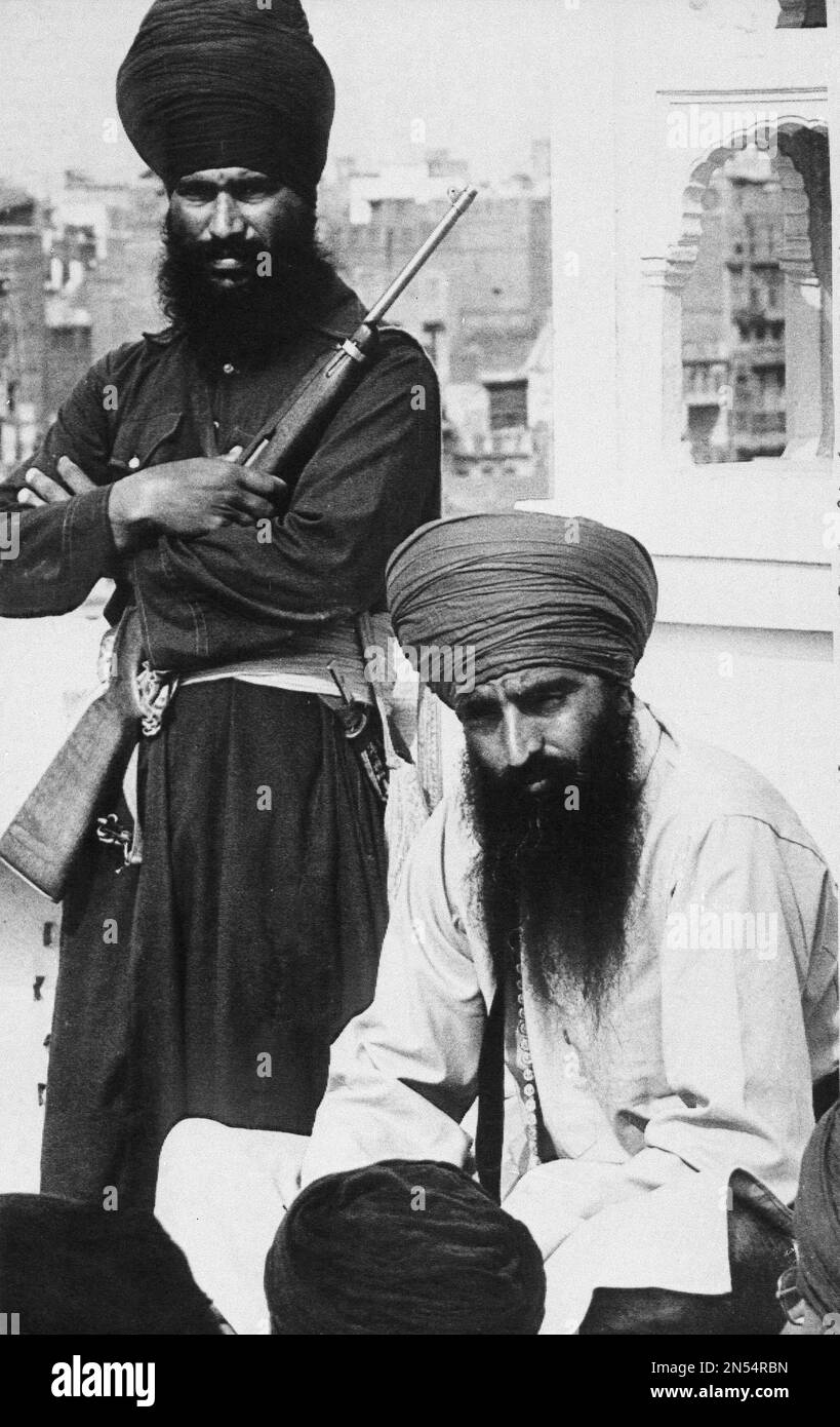 The militant Sikh leader Jarnail Singh Bhindranwale, seated, and an armed bodyguard in his sanctuary within the Amritsar Golden Temple, April 7, 1983. (AP Photo/Sondeep Shankar) Stock Photo