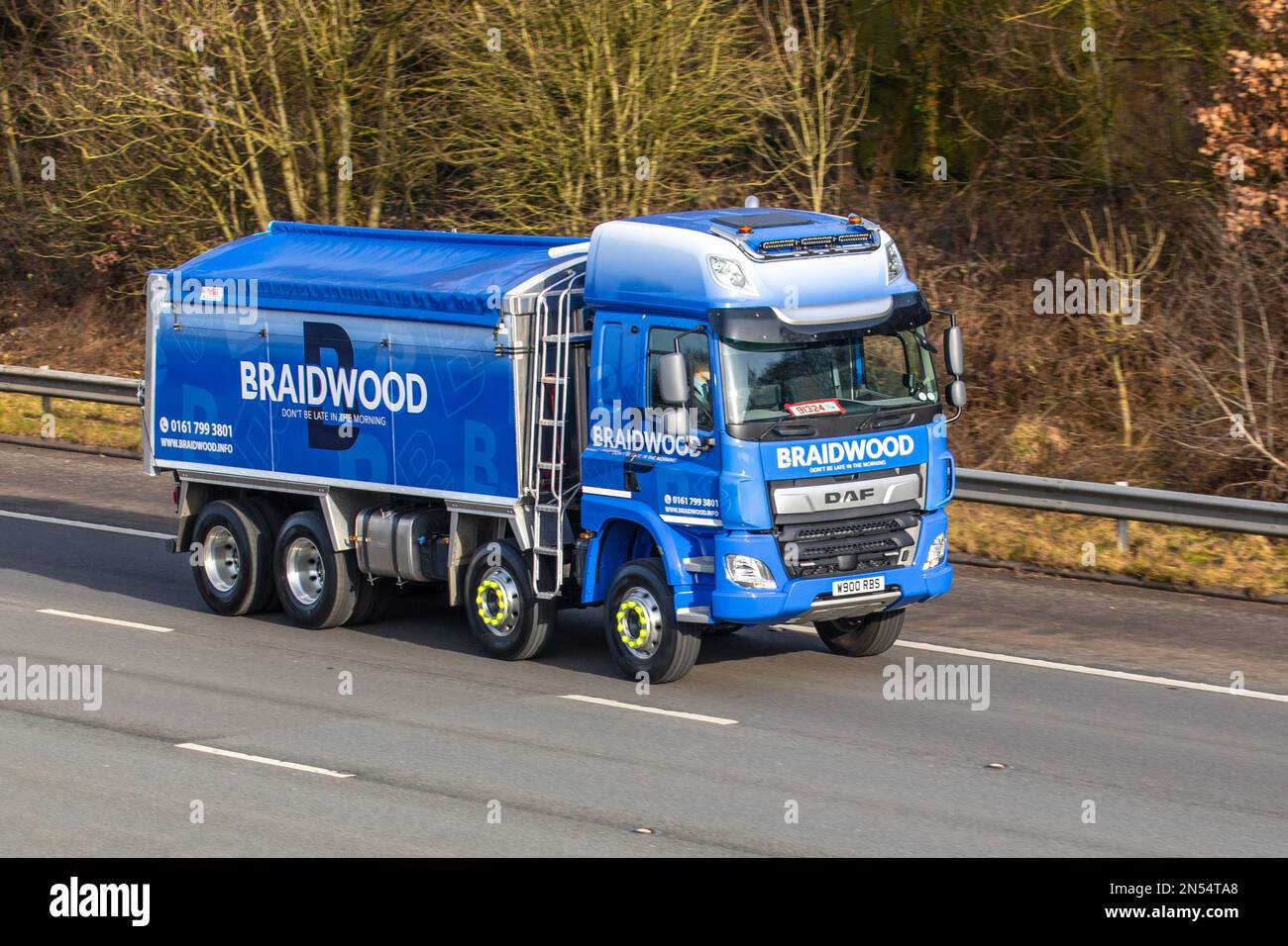 Braidwood & Sons Transport Ltd 'Don't be late in the morning' Blue DAF CF truck, Road Haulage Services vehicle travelling on the M61 motorway, UK Stock Photo