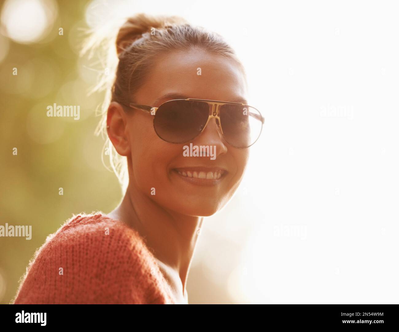 To be young and free. Low angle portrait of a beautiful young woman ...