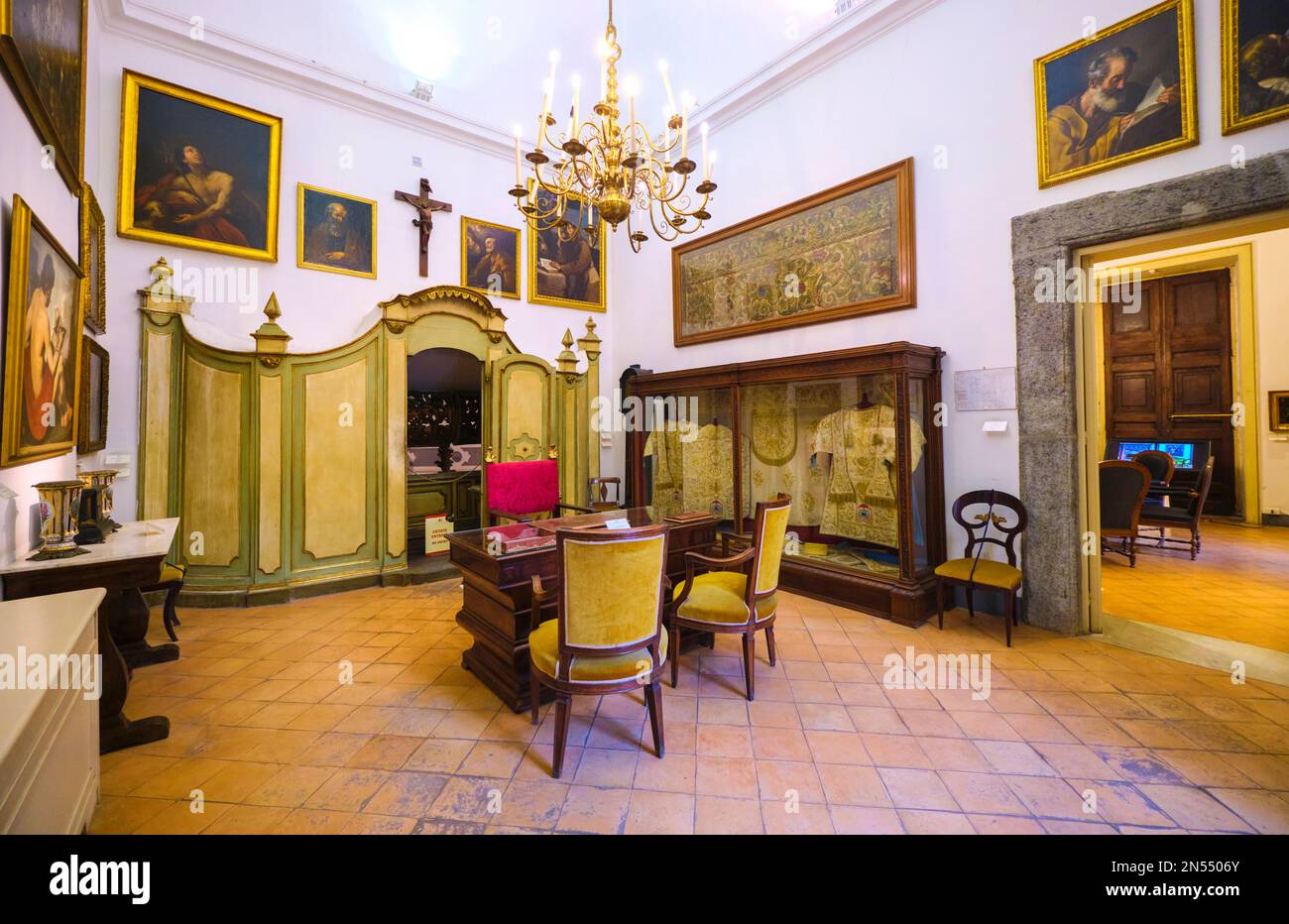 Upstairs from the chapel that houses the famous Caravaggio painting, a collection of period furniture from the Christian foundation.  At the Pio Monte Stock Photo