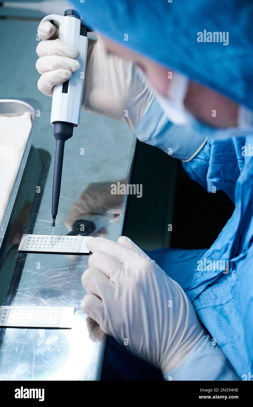 Laboratory technician works with slide for mass spectrometer Stock