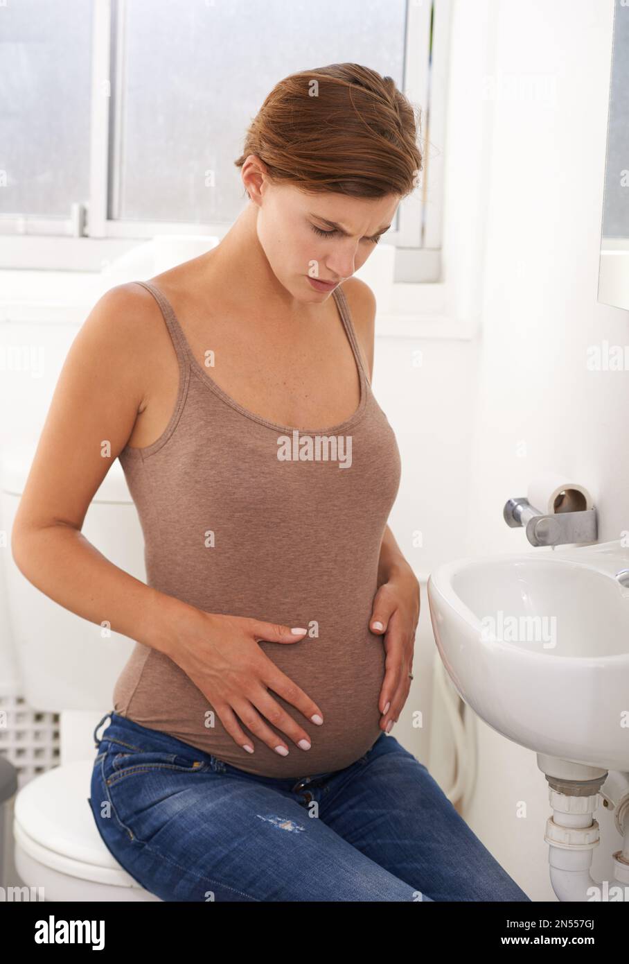 Is this normal. a pregnant woman holding her stomach in in