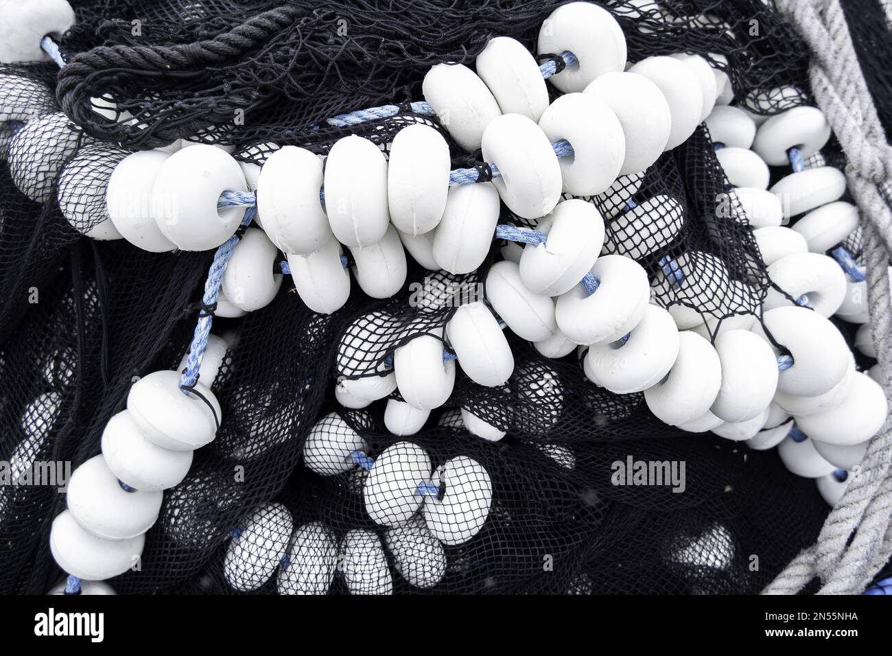 Detail of old deep sea fishing nets on a commercial dock Stock Photo