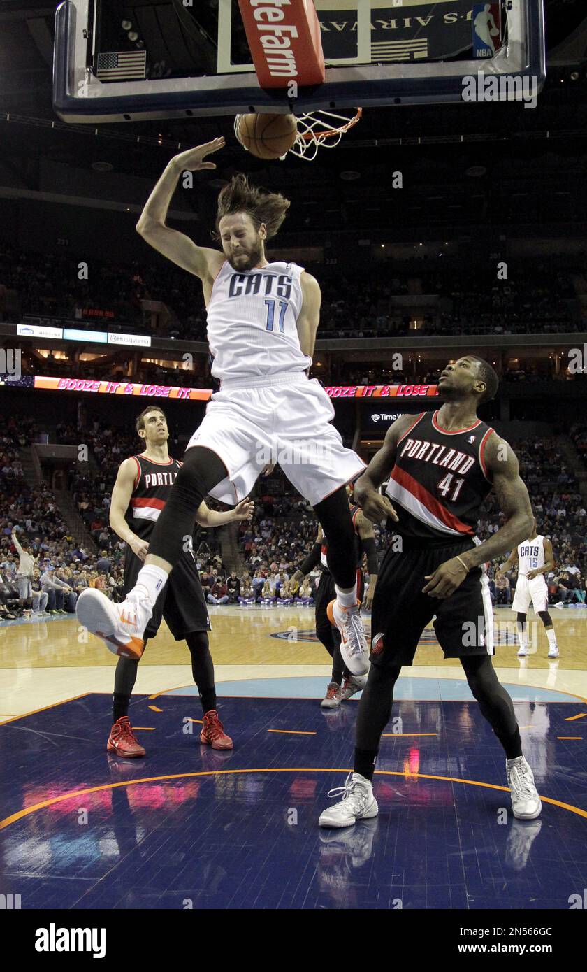 Charlotte Bobcats' Josh McRoberts (11) dunks against Portland Trail Blazers'  Victor Claver, left and Thomas Robinson, right, during the second half of  an NBA basketball game in Charlotte, N.C., Saturday, March 22,, image size:840x1390