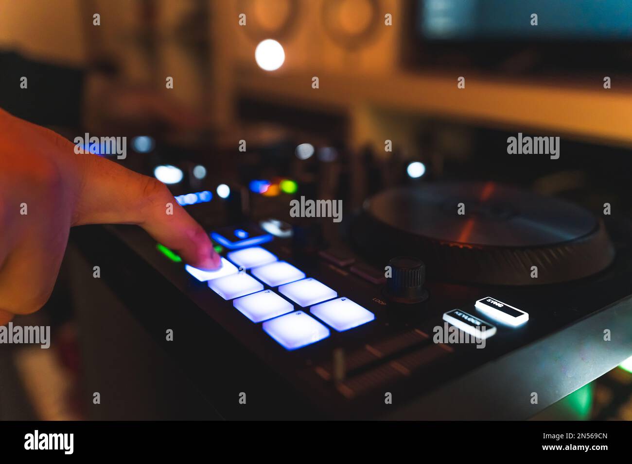 Closeup of man hands making music beats and sounds with a drum pad 