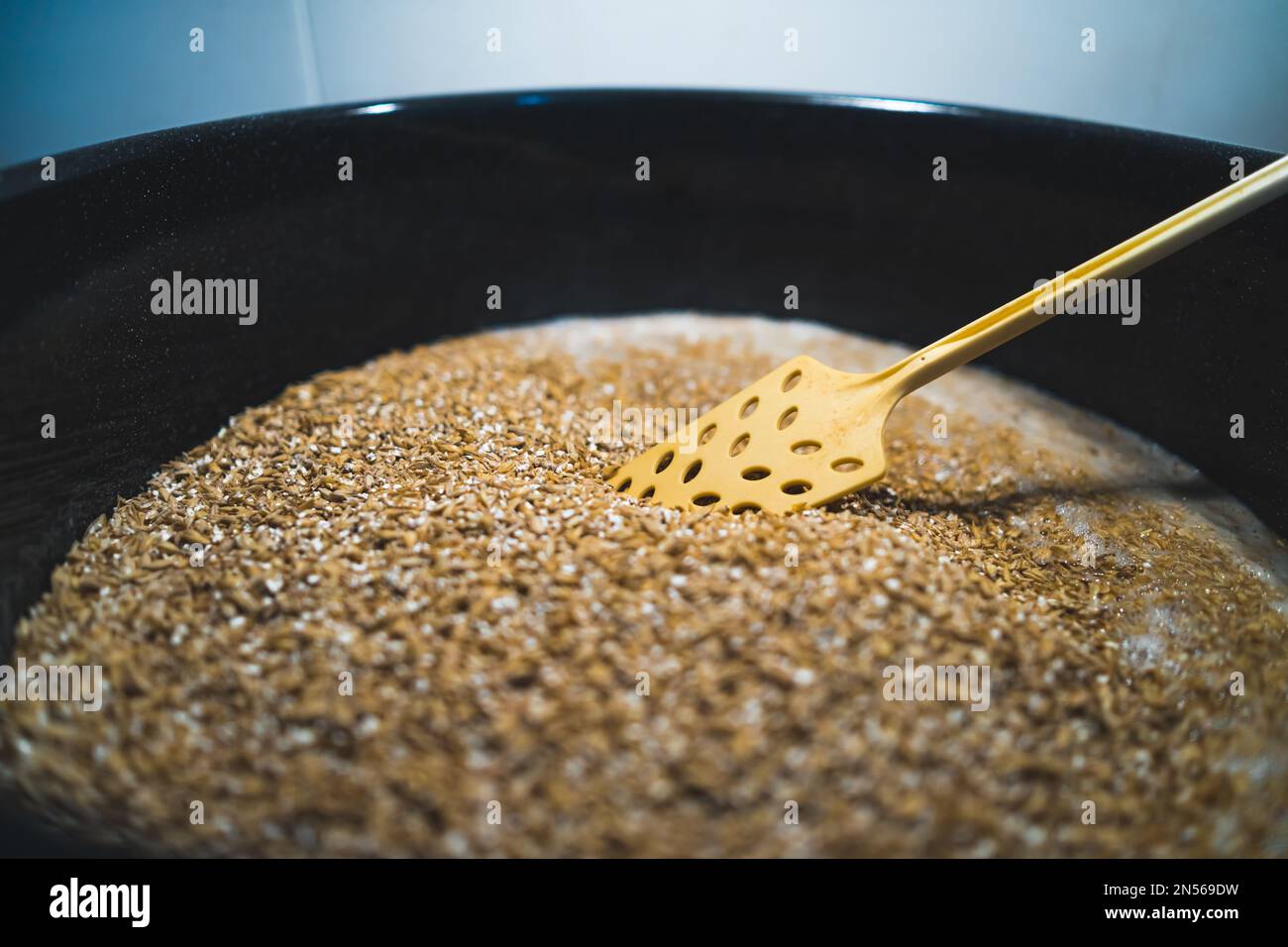 Adding malt to water for sweetening process. High quality photo Stock Photo