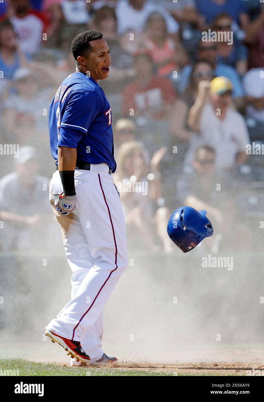 Texas Rangers' Leonys Martin reacts to originally being called out at home  plate during the third inning of a spring exhibition baseball game against  the San Diego Padres, Sunday, March 23, 2014,