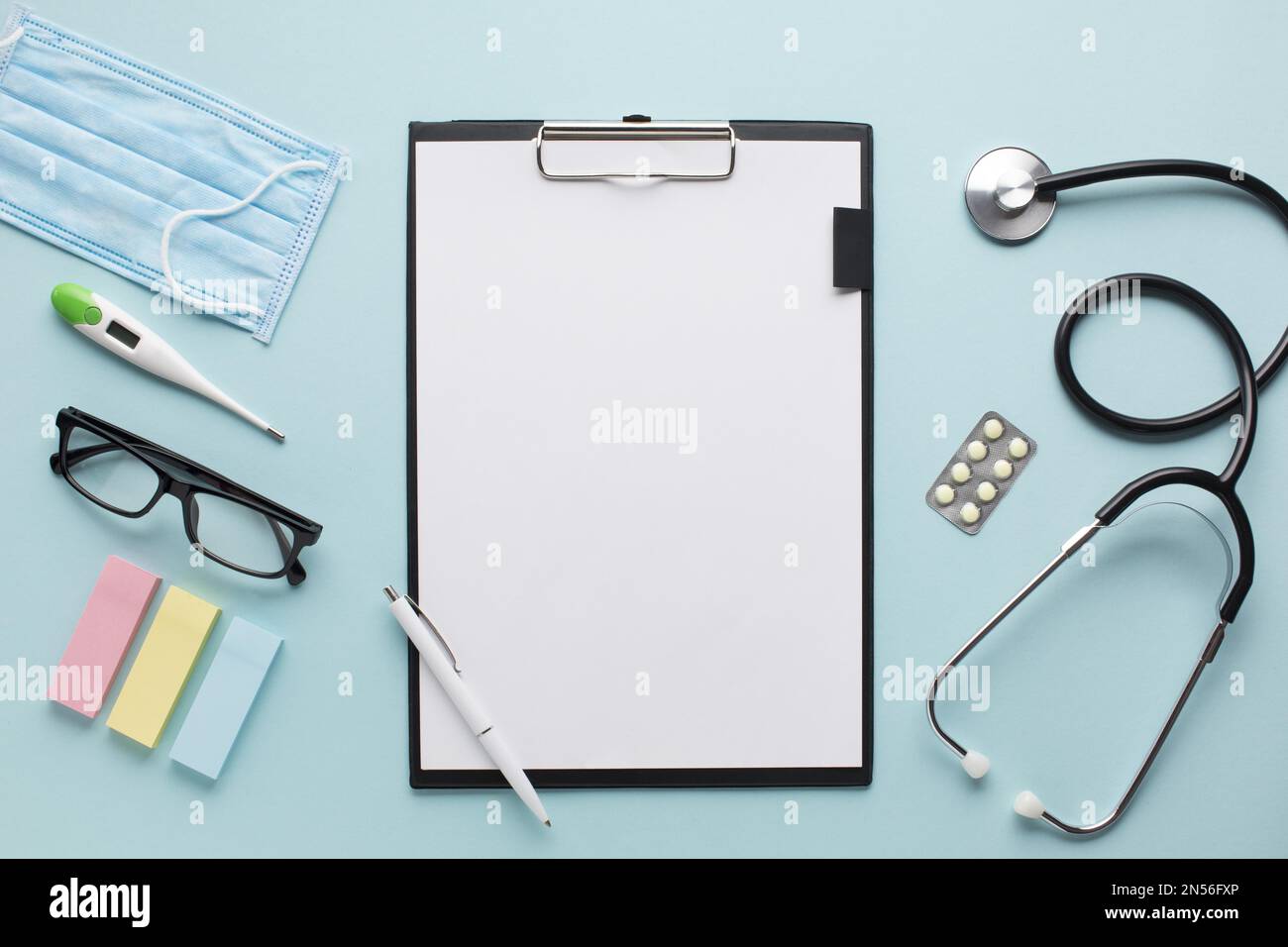 overhead view healthcare accessories near clipboard with plank paper