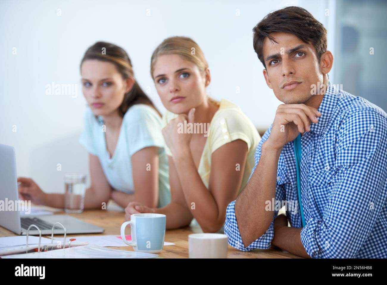 Ideas on the brain. three colleagues working in an office. Stock Photo