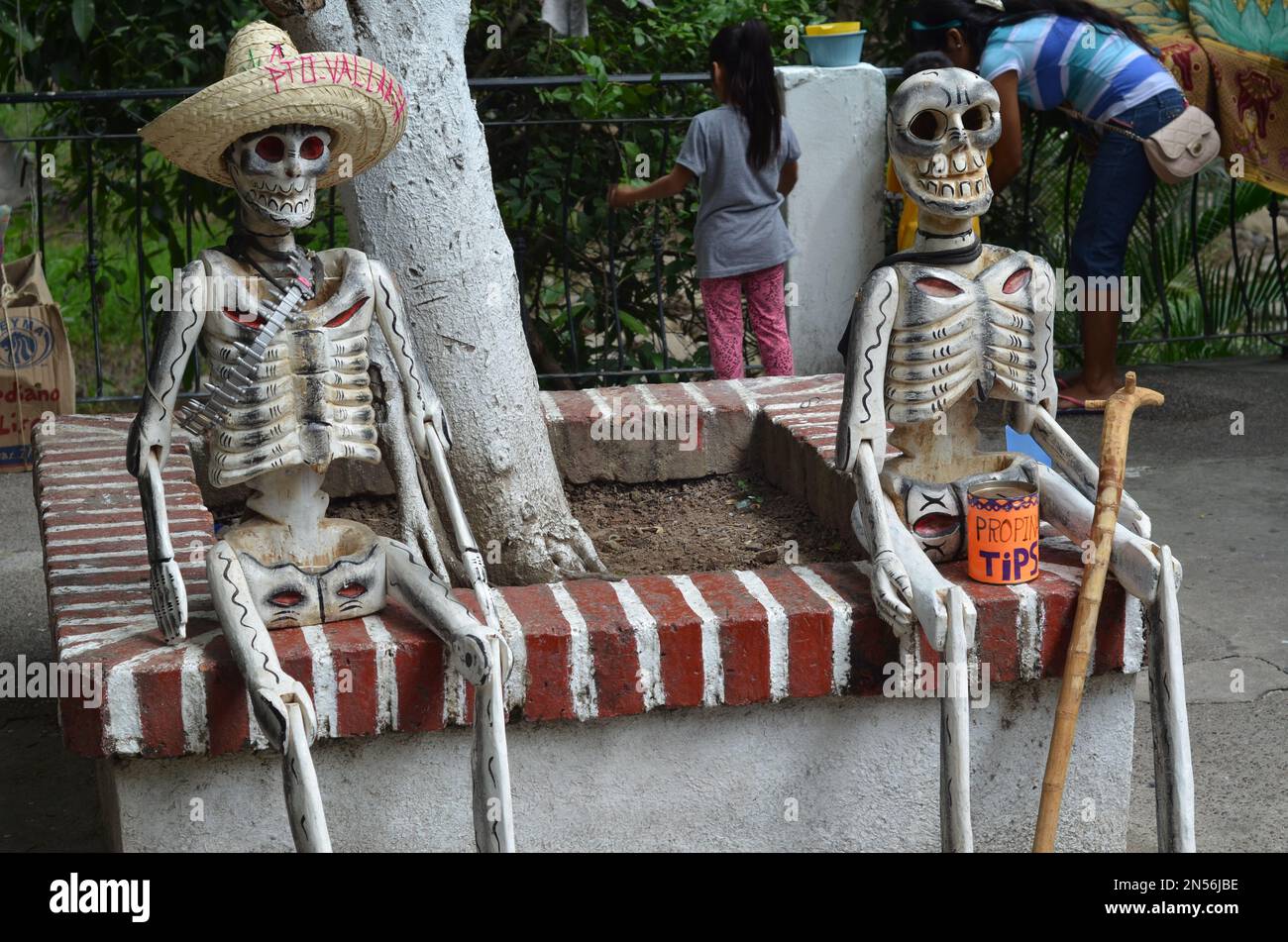 The skeleton figures sitting outdoors in front of the plaza in Puerto Vallarta Mexico Stock Photo